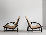 two chairs in a room with a white wall and a white floor