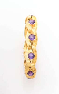 a close up of a gold ring with purple stones on it