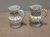 two vases that are sitting on a table