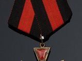 an image of a medal with a cross on it on a black background