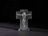 a close up of a cross on a table with a black background