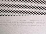 a close up of a metal surface with holes on it