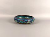 an image of a blue and green bowl on a white surface