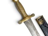 a knife that is sitting next to a knife on a white surface