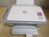 a white printer sitting on top of a wooden table