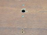 a close up of a piece of wood with holes in it