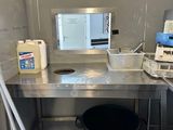 une photo d'une cuisine avec un évier et un micro-ondes