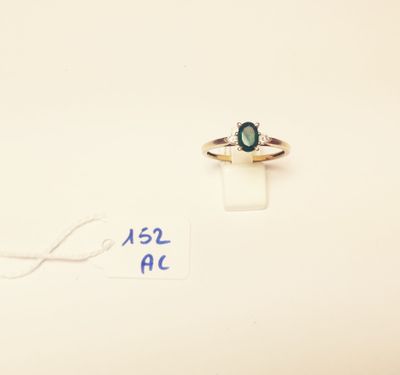 a ring with a green stone on it and a price tag