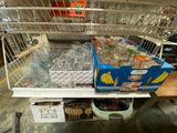 many bottles of water in a cage on the shelf