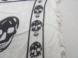 a black and white picture of skulls on a pillow
