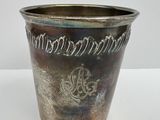 a silver vase with a design on it