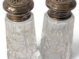 pair of clear glass salt and pepper shakers with metal tops