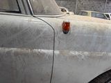 a dirty car that is parked in a garage