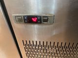 a digital clock on the side of a stainless steel refrigerator