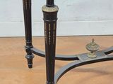 a black and gold table with a clock on top of it