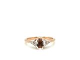 a close up of a ring with a brown and white diamond