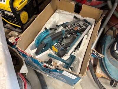 a box of tools sitting on the floor next to other tools