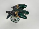 a bird that is sitting on top of a vase