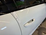 a white car with a sticker on the side of it