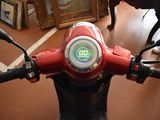 a close up of a motorcycle with a clock on the handlebars