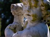 a statue of a little boy holding a teddy bear