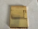 a gold lighter sitting in a box on a table