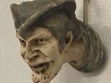 a statue of a man with a hat on a wall