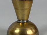a small gold vase sitting on a white surface