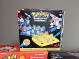 two boxes of pokemon board games sitting on a table