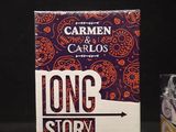 a box of long story short next to a box of candy