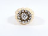 a close up of a diamond ring on a white surface