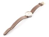a close up of a watch on a white surface with a white background