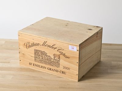 the wooden box is holding a bottle of wine on a wooden table