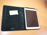 a tablet that is sitting on a table with a notepad