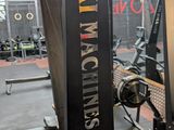 a gym with a weight machine in the middle of the room
