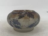 a blue and white bowl sitting on a white surface
