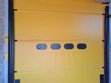 a yellow garage door with black trims in a building