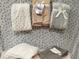 a table with a bunch of blankets and blankets on it