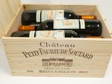 bottles of wine in a wooden box on a white surface