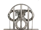 a metal sculpture of a clock on a stand