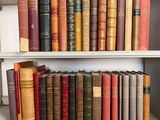 many old books on a shelf in a library