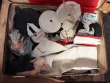 a suitcase full of clothes and other items sitting on the floor