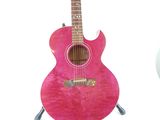 a pink guitar that is sitting on a stand