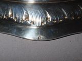 a silver plate that has some sort of design on it