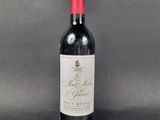 a bottle of red wine sitting on top of a table