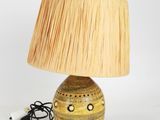 a lamp that is sitting on a table with a lamp shade on it