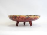 a large bowl with a wooden stand on a white surface