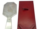 a red case that has a silver spoon in it