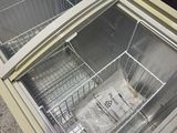 a refrigerator with a glass door that has a basket inside of it