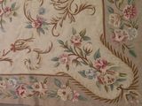a picture of a rug with a bird and flowers on it